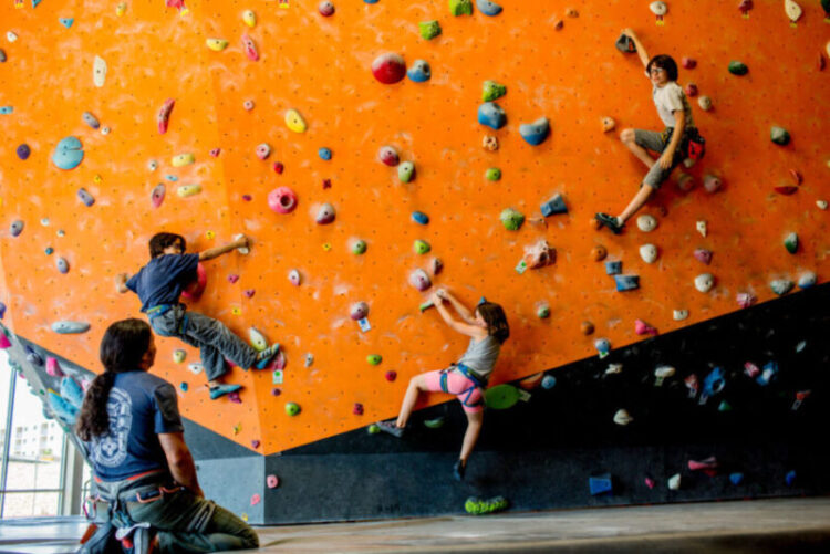 Family climbing on wall